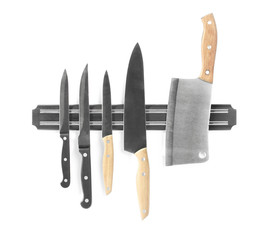 Magnetic holder with different knives isolated on white