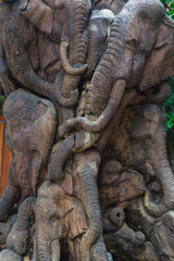 Thai elephants carved on old wood at public temple