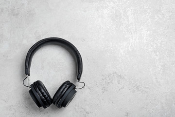 Stylish headphones on grey background, top view. Space for text