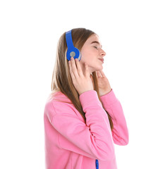 Naklejka premium Teenage girl enjoying music in headphones on white background