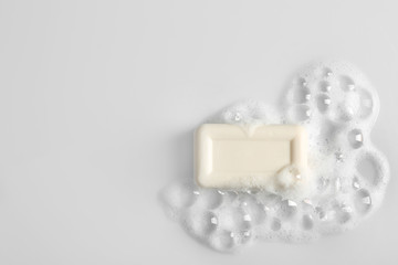Soap bar and foam on white background, top view. Mockup for design