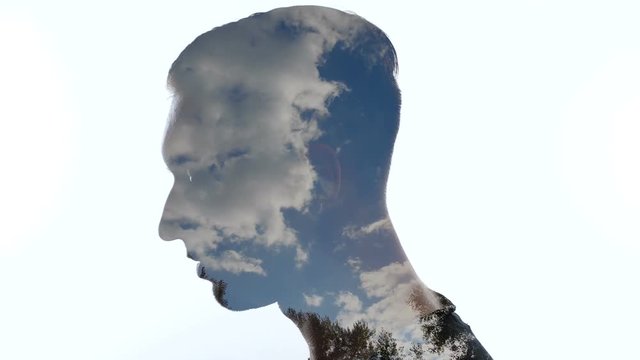 Portrait of pensive man and clouds in the sky - Double exposition
