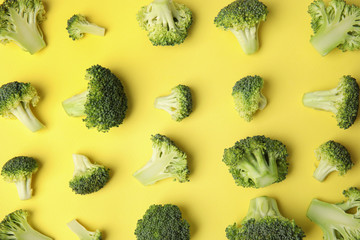 Flat lay composition with fresh green broccoli on color background