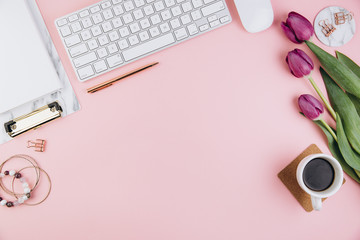 Flat lay, top view office table desk frame. Feminine desk workspace with succulent, laptop, glasses, diary and golden clips on pink background