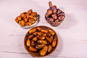 Date fruits on the white wooden table