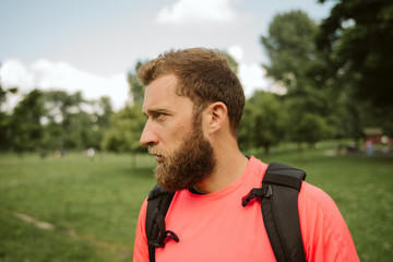 Handsome young caucasian goes on hiking
