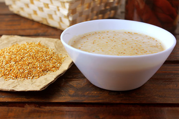 Tahini in ceramic bowl on rustic wooden table- cream or paste made from sesame seeds (sesame) widely used in Middle Eastern cuisine