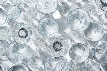 top view of glasses with clear water on white background