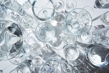 top view of transparent glasses with water on white background