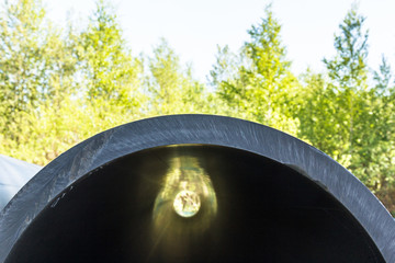 HDPE High Density Polyethylene close up pipe for water supply at construction site construction of a water supply system plastic pipes for water supply of the city, lie on a grass