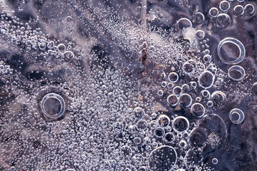 Texture abstract closeup background ice with bubbles of air caught by frost in the mass of water...