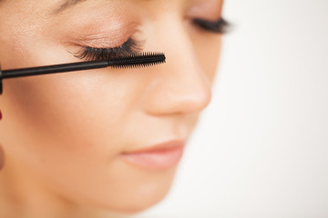 Eyelashes extensions. Fake Eyelashes. Eyelash Extension Procedure. Professional stylist lengthening female lashes. Master and a client in a beauty salon