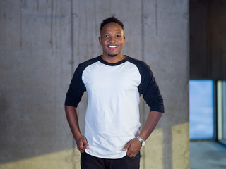 portrait of black businessman in front of a concrete wall