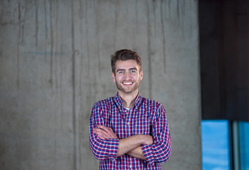 portrait of casual businessman in front of a concrete wall