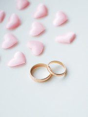 Wedding rings on a white background in pink hearts