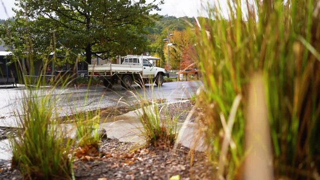 A ute drives through a small town
