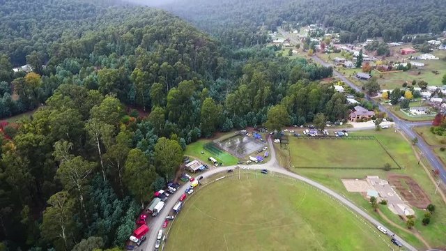 Aerial shot of a small town with cloudy mountain backdrop