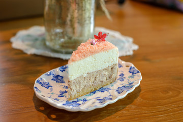 Piece of homemade taro cake in classic plate on table with copy space for text
