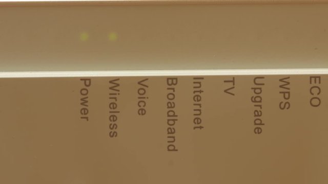 Modern router with green blinking LED lights, starts up, close up