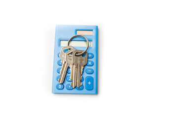 Keys on mini blue calculator isolated, home, security, bank loan, financial concept, future family planning, close up selective focus, copy space.