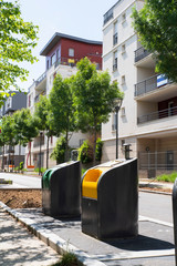 Waste bins in a city centre of Massy in France in front of a building