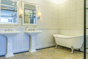 Modern bathroom interior with lighting, white toilet, sink and bathtub
