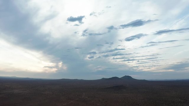 Aerial Drone View of pastel blue sunrise sky over barren Mojave Desert