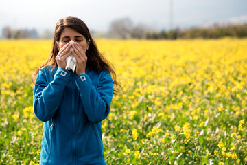 The woman polen allergy with yellow flowers.