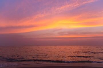 Sunset on a beach with colorful sky in twilight time.
