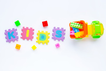 Colorful Kids toys with alphabet "KIDS" Puzzle Pieces  on white.