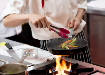 Chef preparing food in the kitchen, chef cooking, closeup