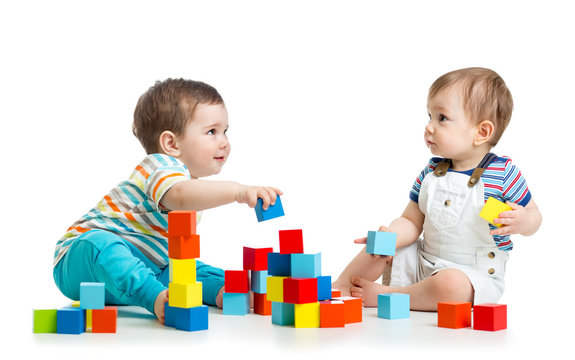 Two babies building block towers. Isolated on white background
