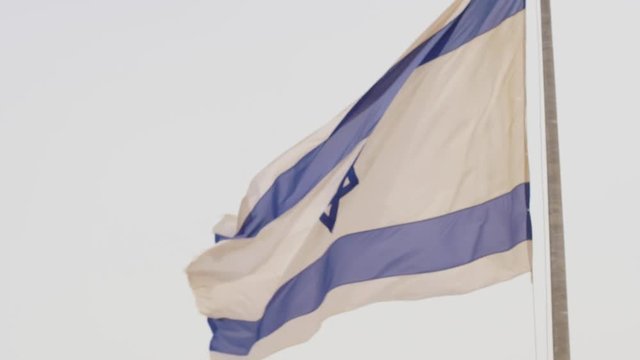 4k slow motion shot of an Israeli flag gently flapping in the breeze.