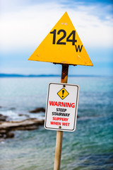 A 'Warning - Steep Stairway Slippery When Wet' sign installed at a boat ramp in Lorne, Victoria,...