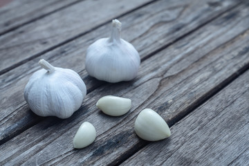 Top view of herbal vegetable ingredients, fresh garlic, on old wooden table, cooking preparation concept