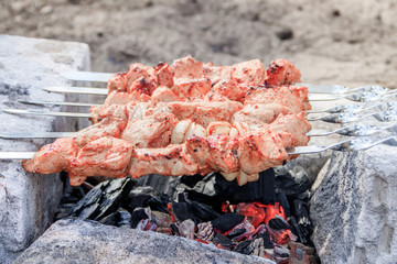 pork shish kebab on skewers. marinated meat. meat kebab. skewers on skewers. cooking on fire.