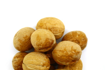 A small pile of walnuts on a white background close-up