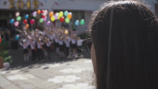 Graduates in the school at a festive event with balloons