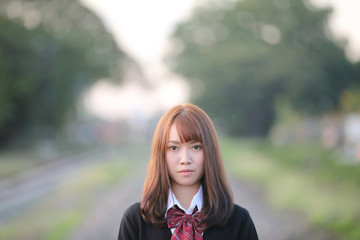 Portrait of asian japanese school girl costume looking at park outdoor film vintage style