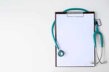 Blank medical clipboard with stethoscope on white background. - Powered by Adobe
