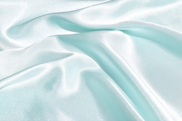 Fototapeta premium The texture of the satin fabric of green color for the background