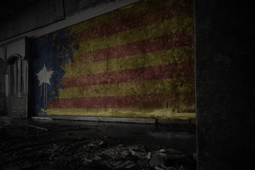 painted flag of catalonia on the dirty old wall in an abandoned ruined house.