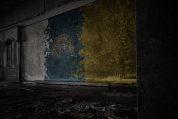 painted flag of canary islands on the dirty old wall in an abandoned ruined house.