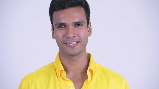 Face of young happy Indian businessman nodding head yes