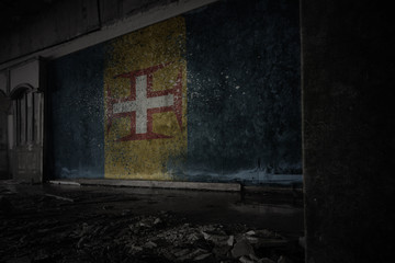 Fototapeta na wymiar painted flag of madeira on the dirty old wall in an abandoned ruined house.