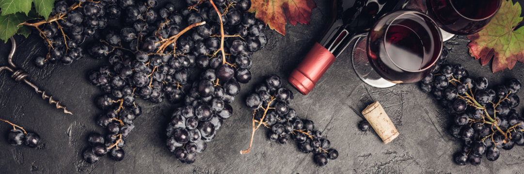 Wine composition on dark rustic background, flat lay