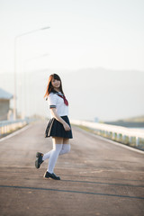 Portrait of Japanese school girl uniform smile with walkway and river