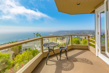 Balcony overlooking the lake and valley under bright blue sky on a sunny day