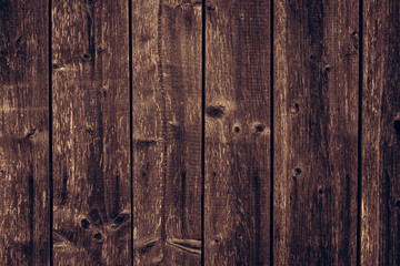 Old wood texture background. Brown shabby wooden fence. Dark brown dirty wood boards. Dilapidated...