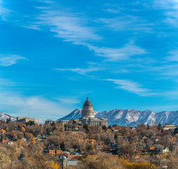 The majestic Utah State Capital Building towering over houses in Salt Lake City